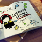a person drawing in a notebook about customer services and outsourcing IT