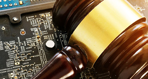 Gavel on top of computer microchip